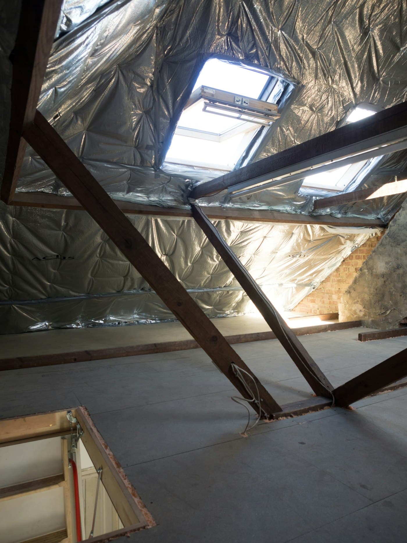 Foil insulation lining a loft roof between rafters