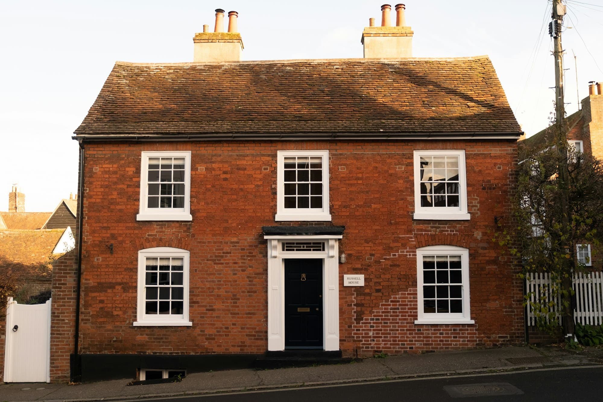 A red-brick Victorian house on a British street